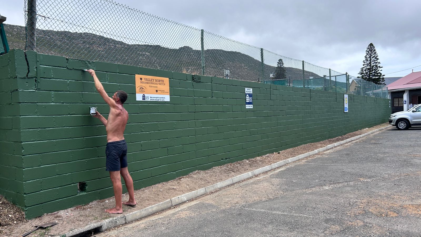 Sin painting the tennis club wall green