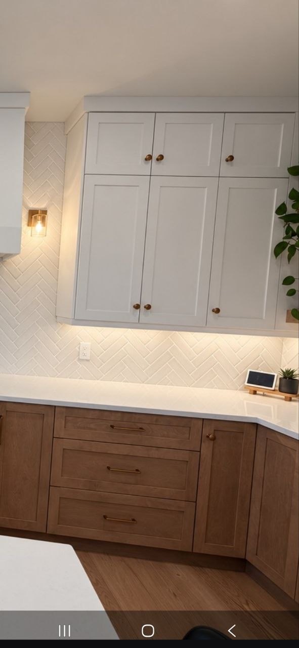 Finished herringbone backsplash above the light countertop in the St. John’s kitchen