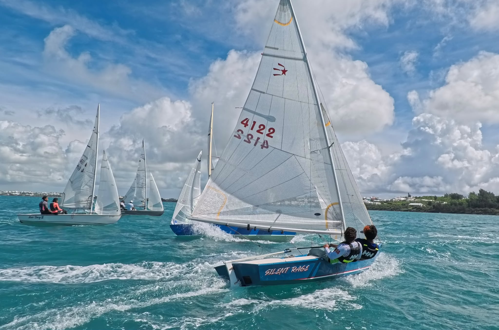 Fleet of dinghies racing off the Bermuda coastline