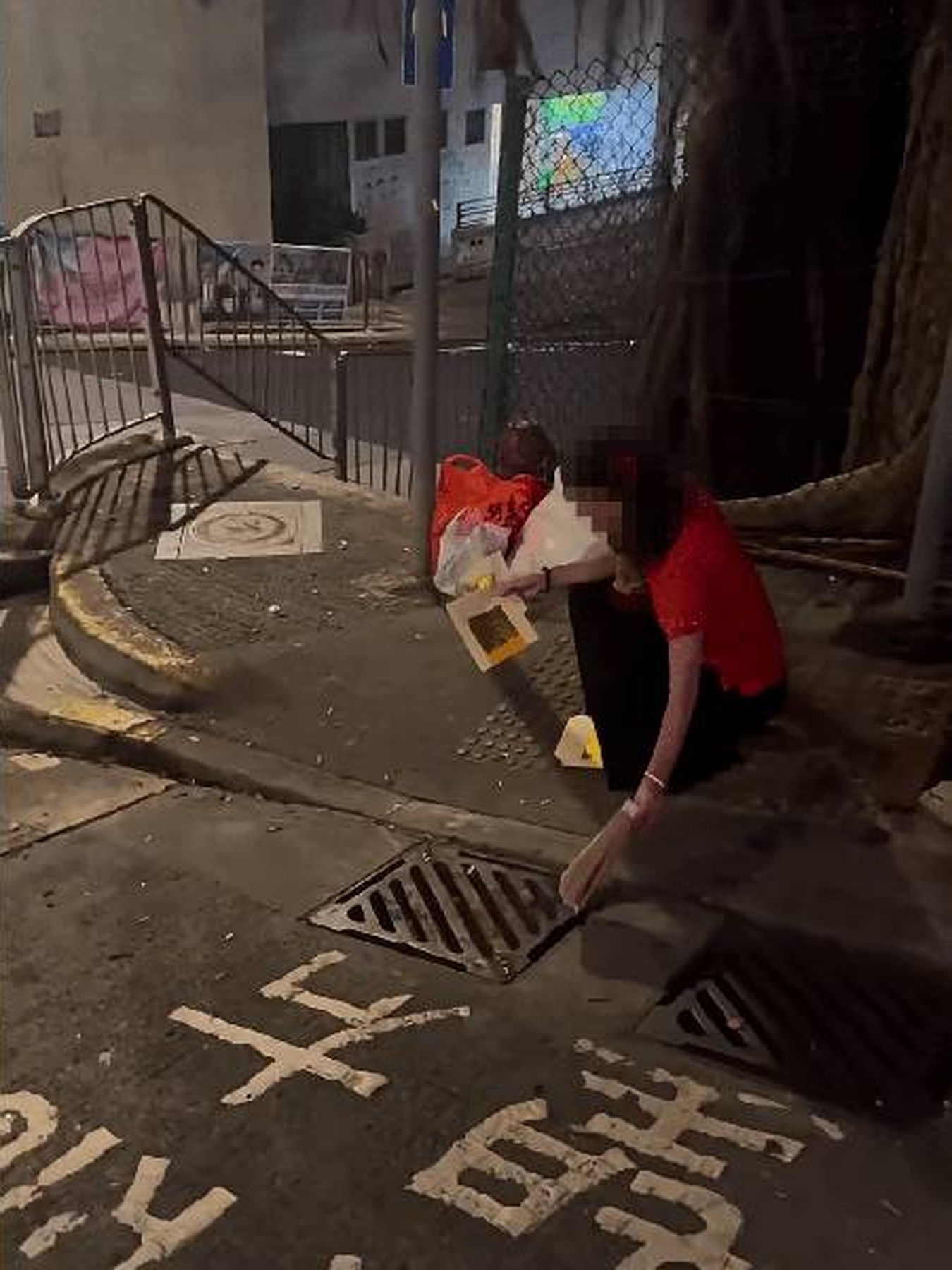 Woman sparks outrage after tossing burning Ghost Festival offerings into Sai Ying Pun drain